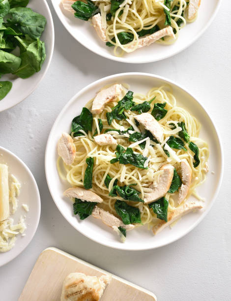 istock Spaghetti with spinach leaves, slices grilled chicken breast and grated cheese 1135279487
