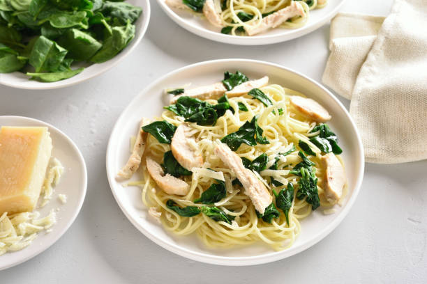 istock Spaghetti with spinach leaves, slices grilled chicken breast and grated cheese 1135279522