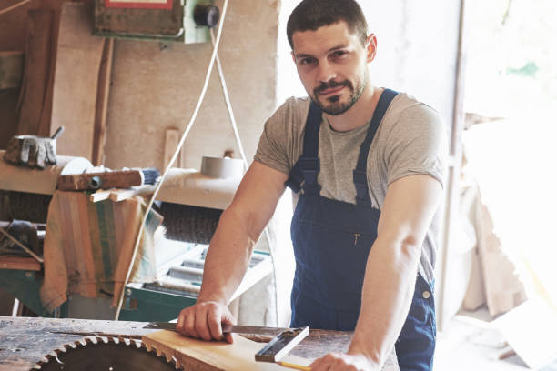istock A man works in a joiner's shop, working with a tree. 1135280389