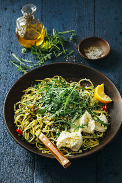 istock Spaghetti with pesto, roasted tomatoes, fresh arugula and mozzarella 1135280817