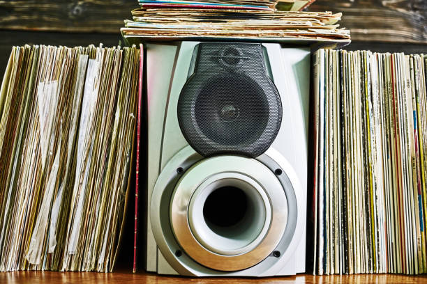 istock Vinyl records and loudspeaker box on hardwood floor 1135282622