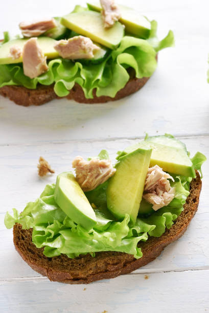 istock Tuna sandwiches with avocado and lettuce leaves 1135283965