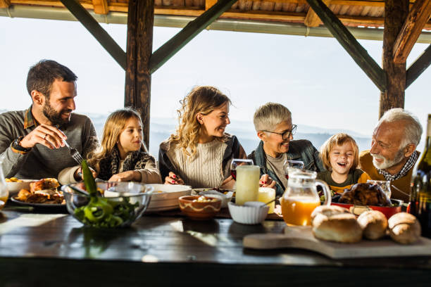 istock Happy extended family talking during lunch on a terrace. 1135285100