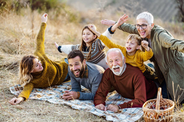 istock Playful extended family having fun on picnic in nature. 1135287448