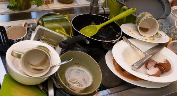 istock washing up piled up in a kitchen sink 1135289017