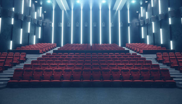 istock Cinema hall with blank screen and empty seats. Modern design with striking lighting, neon lighting. Audio system on the walls. Cinema hall without people. White screen with copy space, 3D illustration 1135289232