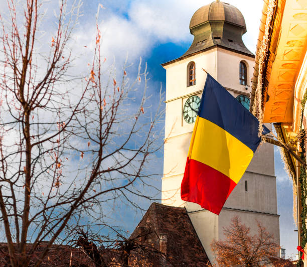 romanian flag and traditional architecture in sibiu, transylvania, romania - romania flag romanian flag colors imagens e fotografias de stock