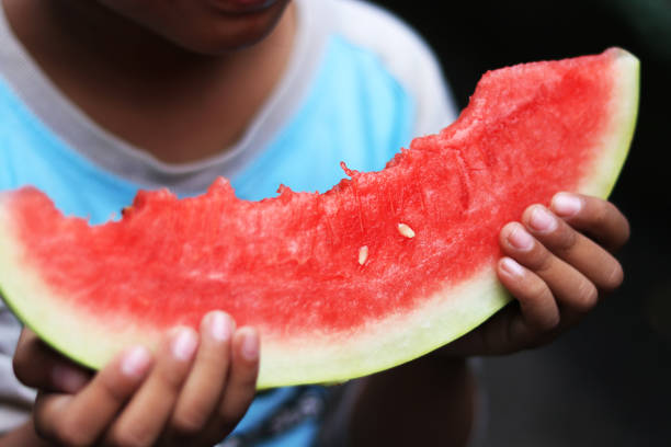 istock little boy eating watermelon 1135290425