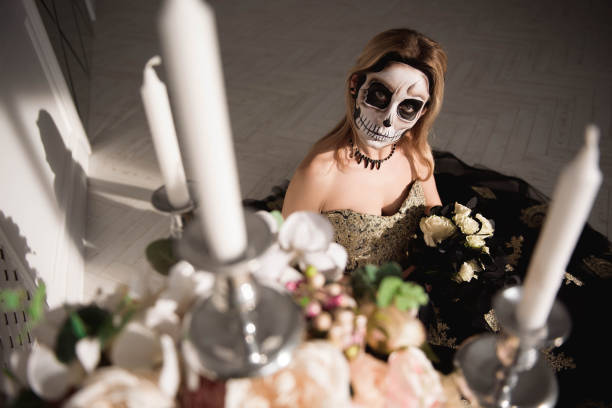 istock Portrait of zombie woman with painted skull face 1135290607