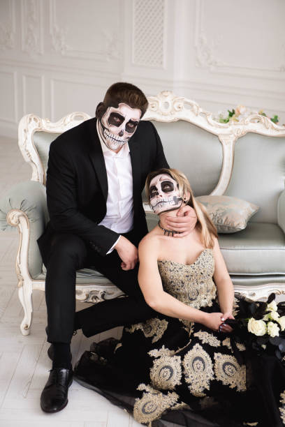 istock Couple with dark skull makeup on white background. Halloween 1135290637