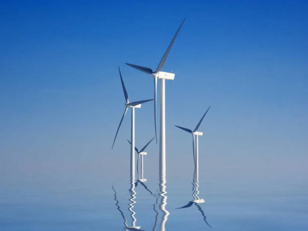 istock wind turbines and reflection in the water 1135291075