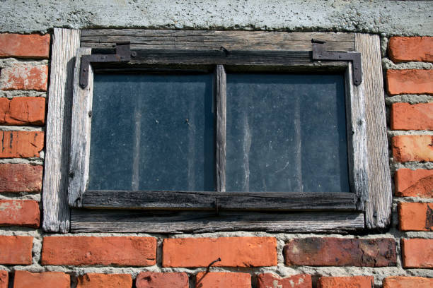 istock Old wooden window with vintage brick framing. 1135291303