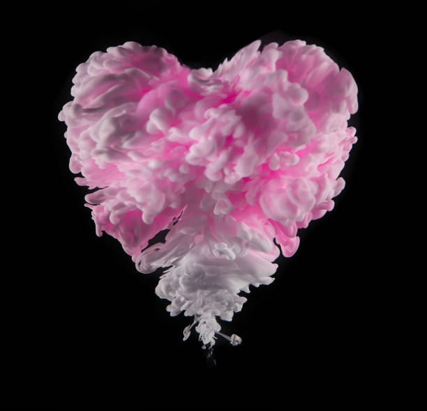 istock Coloured acrylic ink in heart shape on black 1135295455