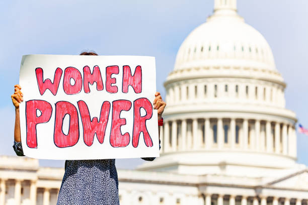 istock Protester holding sign women power in her hands 1135295606