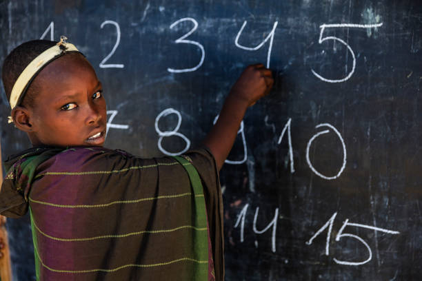istock African young girl during math class, Arbore tribe, Omo Valley, Ethiopia 1135297204