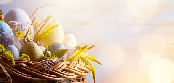 sunny Easter background with Easter eggs in the basket