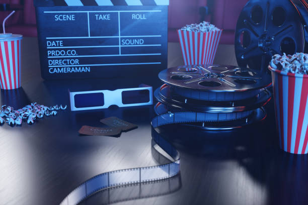 istock 3D illustration with popcorn, cinema reel, clapperboard and two tickets with blue light. Concept cinema hall and theater. Red chairs in the cinema hall in the background. 1135297680