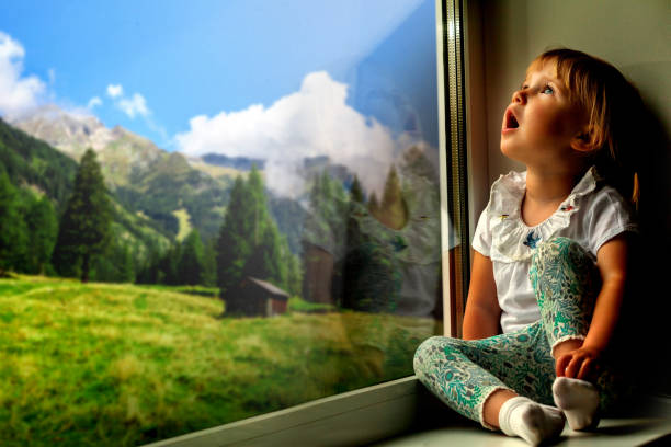 istock the child is looking in the spring window 1135297977