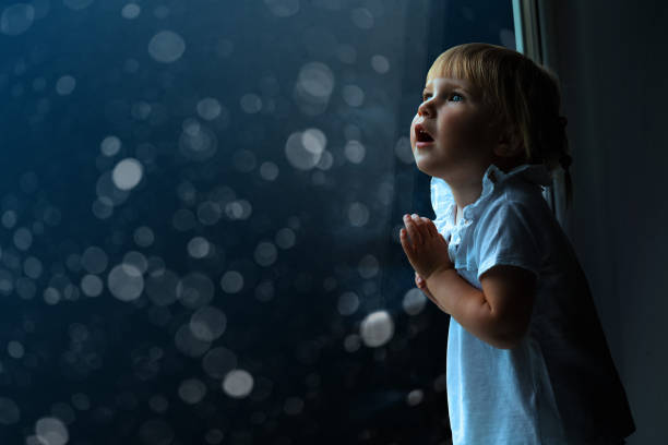 istock the child is looking in the spring window 1135298497