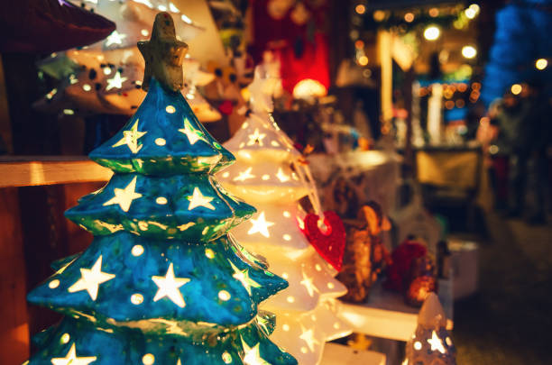 Detail of a traditional christmas market in italy, with a christmas tree shaped lamp stock photo