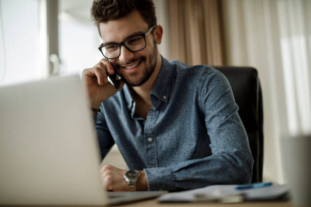 istock Smiling young businessman talking on the phone 1135300984