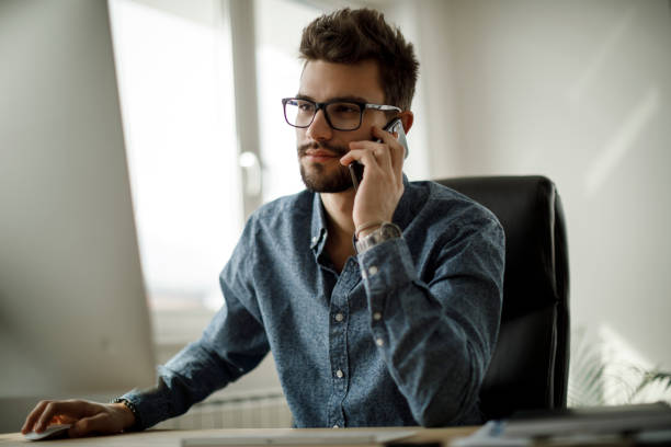 istock Young businessman using mobile phone in office 1135300997