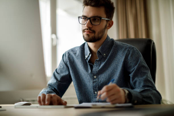 istock Young man working in his new office 1135301293