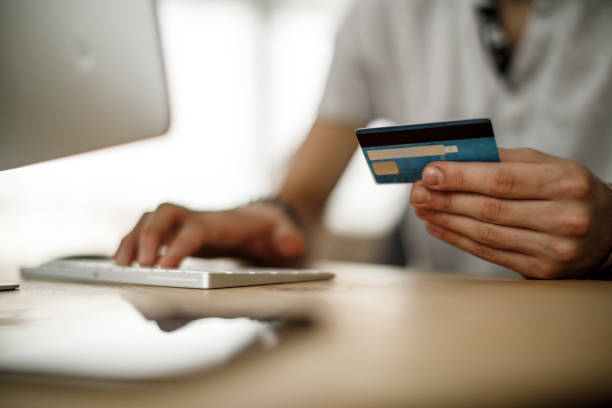 istock Young man shopping online using his credit card 1135301295
