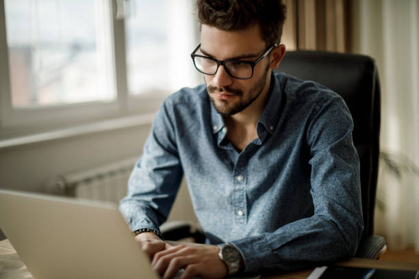istock Young businessman working on laptop 1135301415