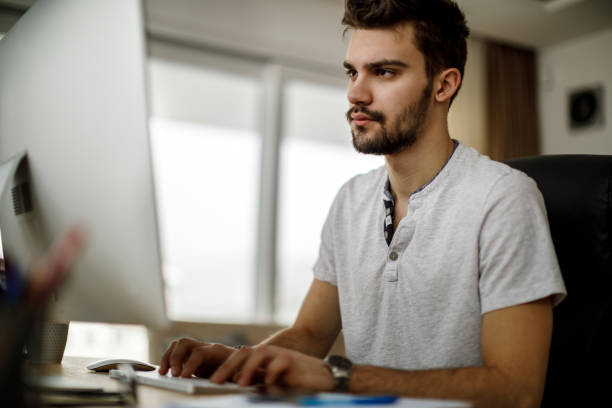 istock Young man looking at computer monitor 1135301779