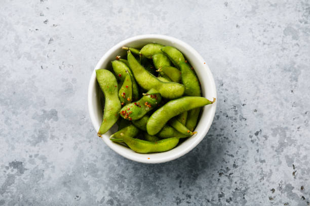 istock Fresh steamed Edamame soybean pod with spice on concrete background 1135301925