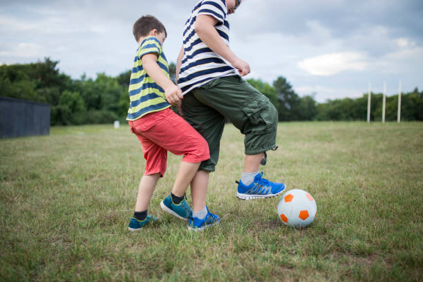 istock Little boys playing football 1135302898