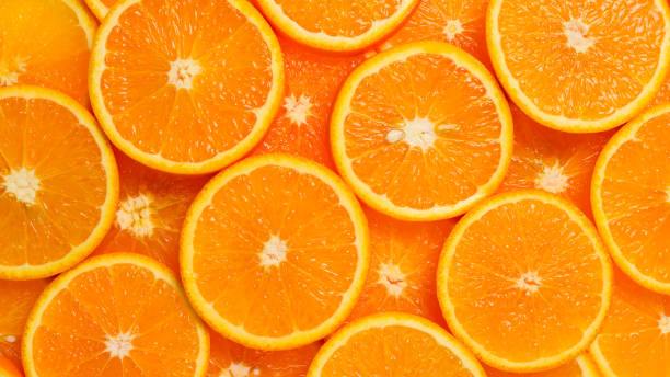 istock Slices of oranges as a background, top view. 1135302968