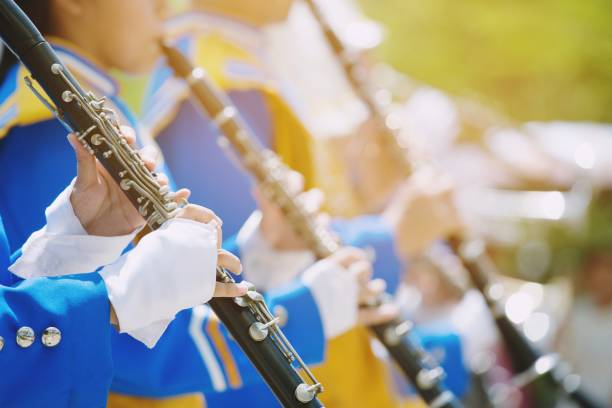 close up show band parade and details of playing musicians instruments in a marching band performing playing a clarinet  woodwind instruments. - marching band imagens e fotografias de stock