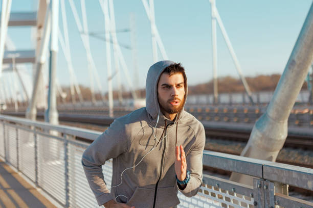 istock Young man running on a city bridge 1135303806