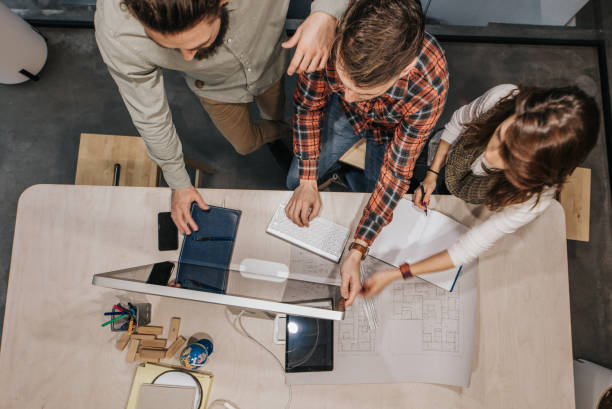 istock Above view of business team cooperating while working on desktop PC in the office. 1135306219
