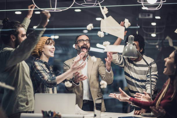 istock Joyful business team celebrating their success in the office. 1135307841