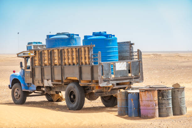Water wagons and water barrels in the middle of the desert of Sudan, Africa Water wagons and water barrels in the middle of the desert of Sudan desert wash stock pictures, royalty-free photos & images