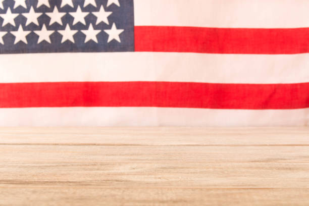istock Wooden table and American flag in the background. Selective focus. 1135309743