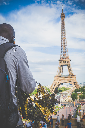 Paris, France - July 31, 2016 : A street trader sell the model of Eiffel in Place Jacques Rueff.