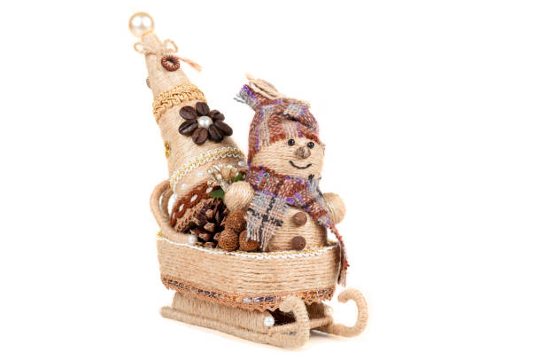 istock snowman with a Christmas tree sitting in a sleigh, isolated 1135314348