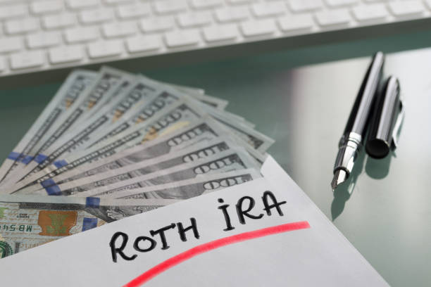 Roth IRA, individual retirement account, plan with cash us dollars on a table Roth IRA, individual retirement account, plan with cash us dollars on a table roth contribution stock pictures, royalty-free photos & images