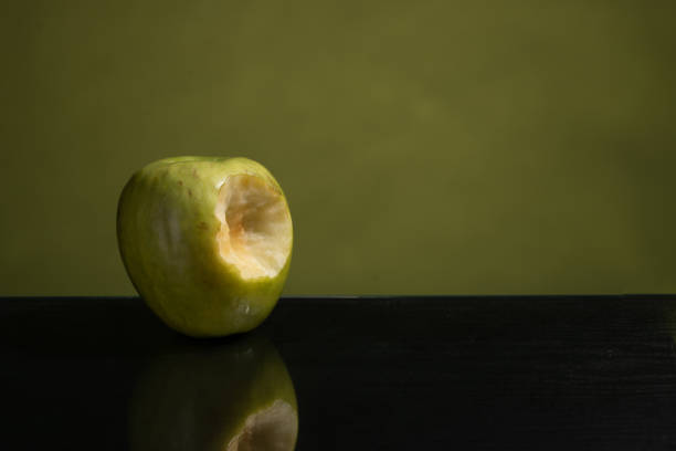 istock Bit green apple, green on one side and green mirror table 1135315966