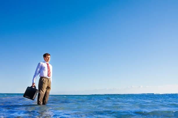 istock Young office white collar worker stand in the sea 1135316761