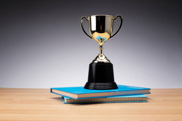 istock trophy on stack of book for education success concept. 1135317741