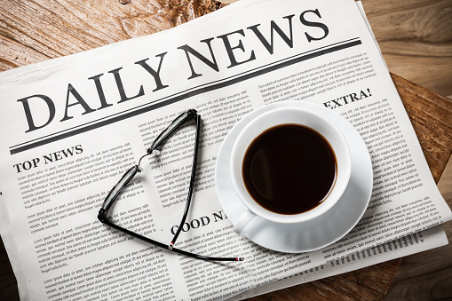 Business Newspaper On Wooden Desk With Glasses And Coffee Cup Daily Newspaper Mockup Concept Stock Photo - Download Image Now - iStock