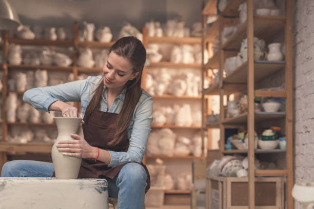 istock Young girl working on a potter's wheel 1135319149