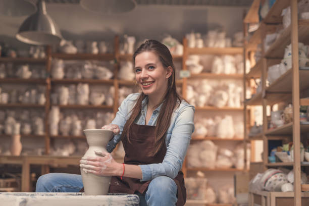 istock Smiling girl working on a potter's wheel 1135319152