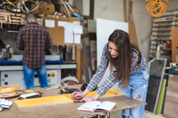 istock Female carpenter takes a measure 1135319306