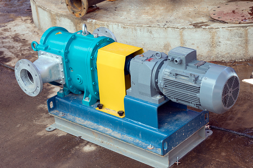 View of the horizontally mounted lobe pump for storage tank. A pump is a device that moves fluids or sometimes slurries, by mechanical action.